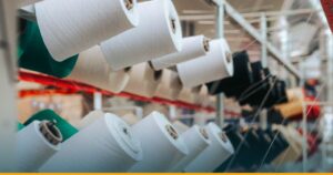 Rolos de material em linha de produção industrial, representando a fabricação de etiquetas VIN Brasil